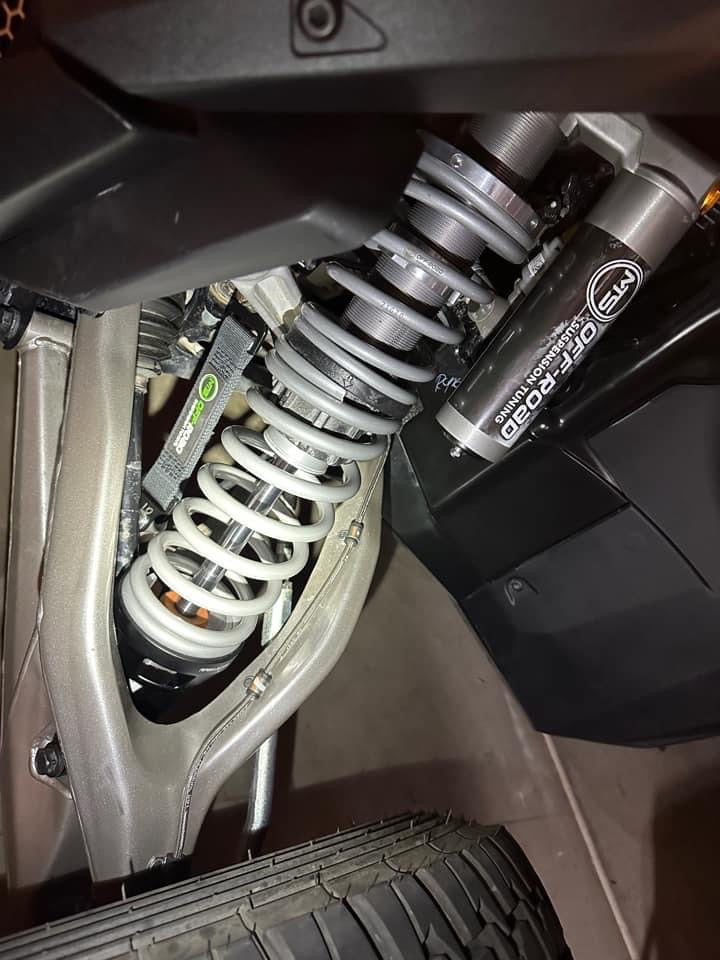 MTS shocks on the underside of a UTV at night gray shocks