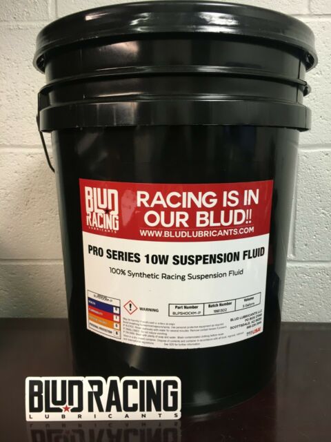 5 gallon pale of Blud Racing 10W suspension fluid, predominantly black in color with red and white labeling.