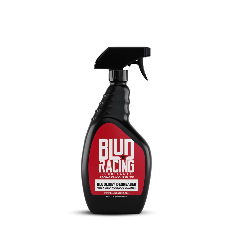 A black spray bottle with red label text indicating the product is 'Blud Racing' Kick-Ass Degreaser.